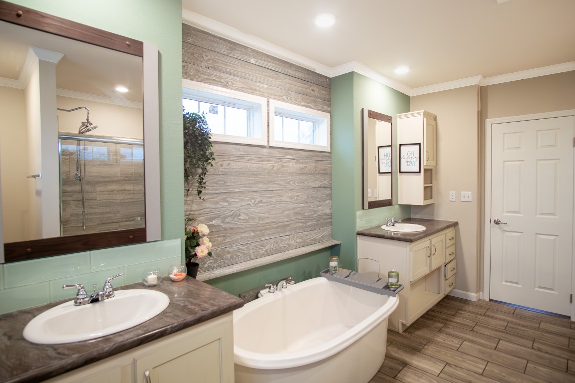 3882 Dry Creek Road Lockhart, TX 78644 - Photo 12 of 18 a bathroom with a granite countertop toilet a sink and a mirror