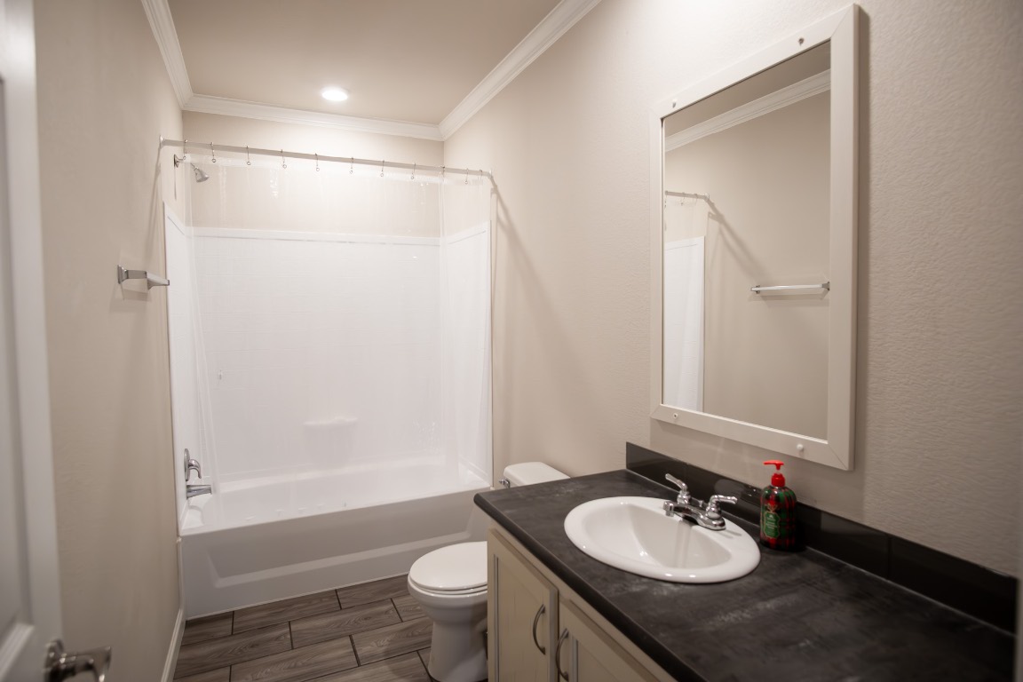 3882 Dry Creek Road Lockhart, TX 78644 - Photo 15 of 18 a bathroom with a double vanity sink toilet mirror and shower