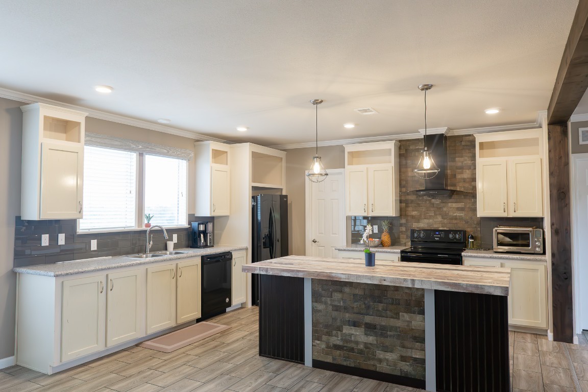 3882 Dry Creek Road Lockhart, TX 78644 - Photo 4 of 18 a kitchen with stainless steel appliances granite countertop a sink a stove and refrigerator