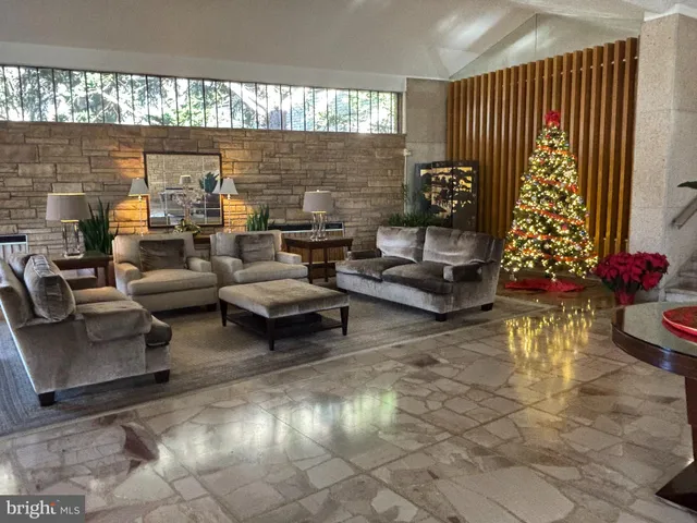 a living room with furniture and flowers