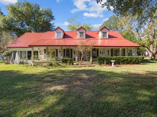 a front view of house with yard and green space