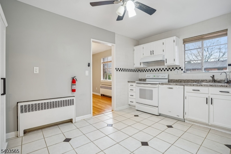 23 Troy Drive, Unit B Springfield, NJ 07081 - Photo 11 of 22 a kitchen with granite countertop white cabinets and white appliances