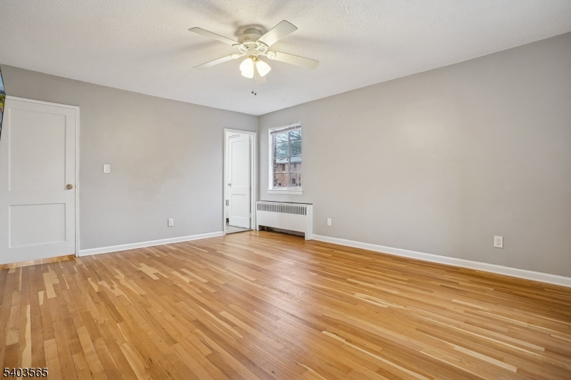 23 Troy Drive, Unit B Springfield, NJ 07081 - Photo 15 of 22 wooden floor in an empty room with a window