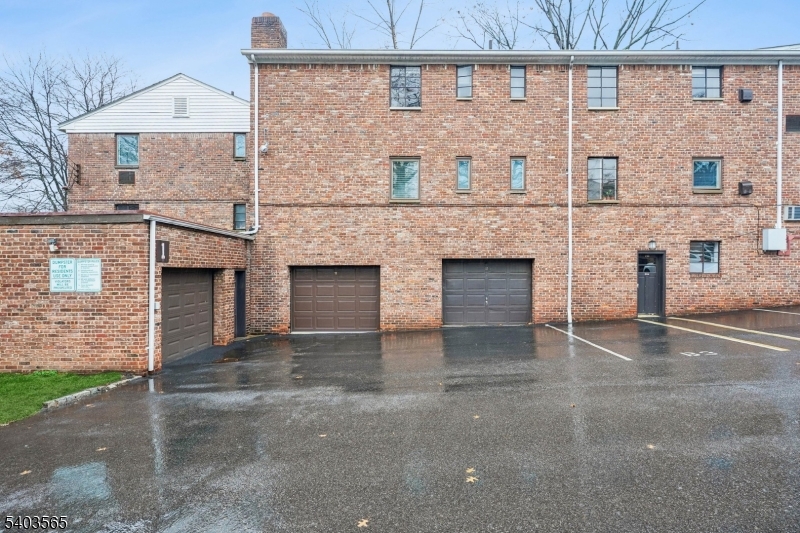 23 Troy Drive, Unit B Springfield, NJ 07081 - Photo 20 of 22 a front view of a building with glass windows and garage