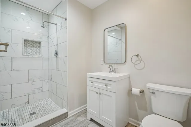 a bathroom with a shower a toilet and sink