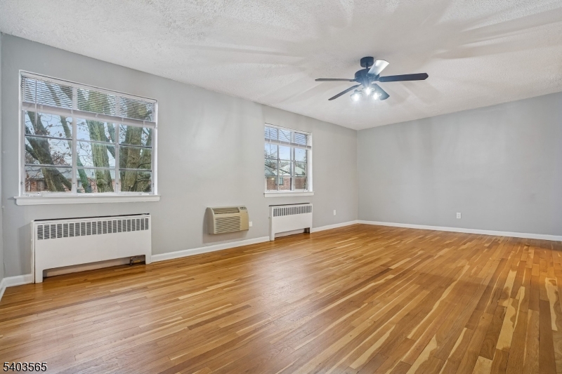 23 Troy Drive, Unit B Springfield, NJ 07081 - Photo 5 of 22 a view of an empty room with wooden floor and a window