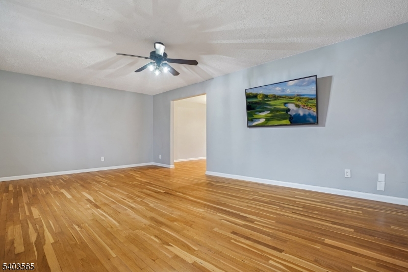 23 Troy Drive, Unit B Springfield, NJ 07081 - Photo 6 of 22 a view of an empty room with window and wooden floor