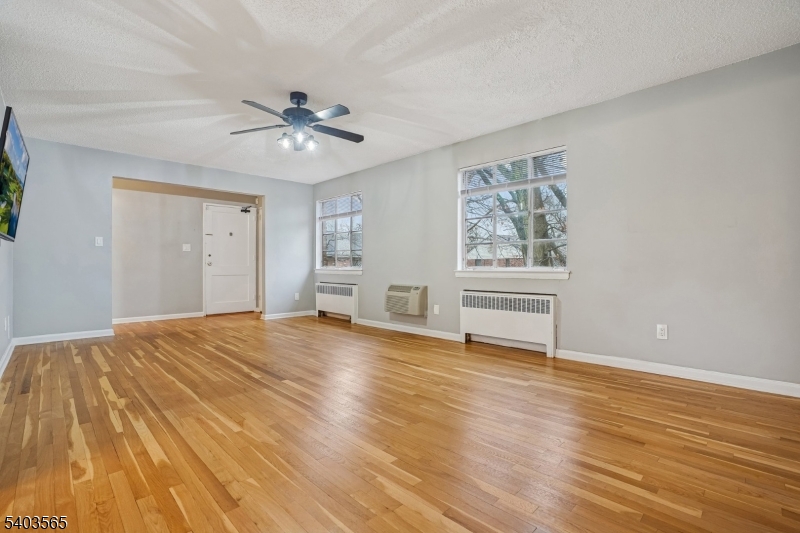 23 Troy Drive, Unit B Springfield, NJ 07081 - Photo 8 of 22 a view of empty room with wooden floor and fan
