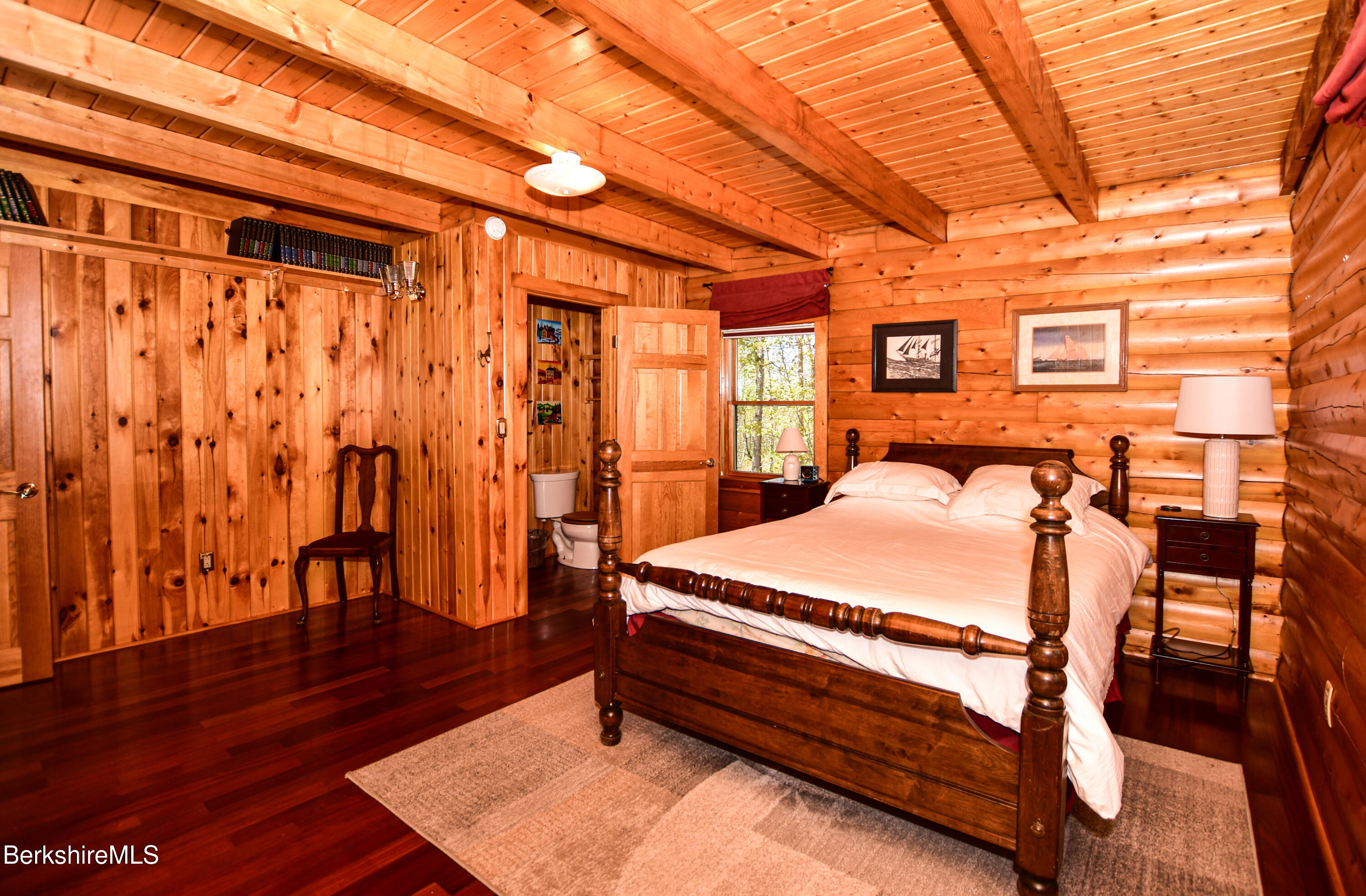 233 Algerie Road Becket, MA 01223 - Photo 19 of 48 a bedroom with a bed and wooden floor