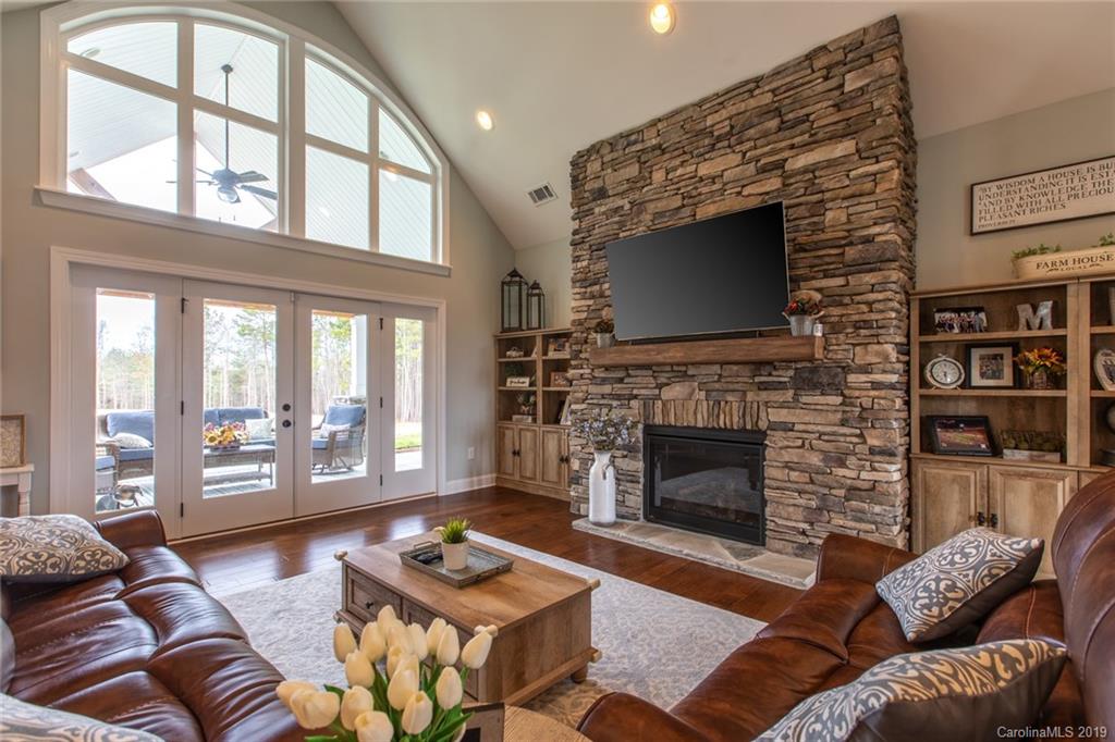 283 Currence Road Clover, SC 29710 - Photo 17 of 35 a living room with furniture a fireplace and floor to ceiling windows