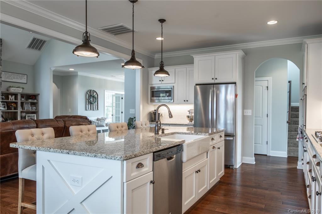 283 Currence Road Clover, SC 29710 - Photo 20 of 35 a kitchen with stainless steel appliances granite countertop a kitchen island a stove a refrigerator a oven and a view of living room