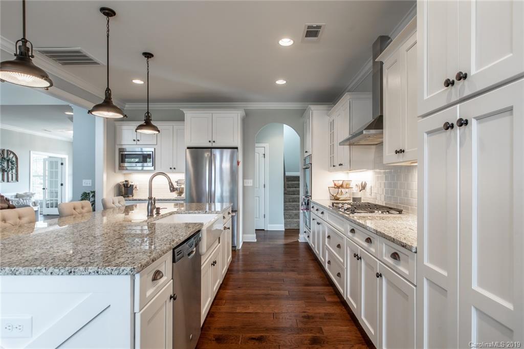 283 Currence Road Clover, SC 29710 - Photo 21 of 35 a large kitchen with granite countertop a large kitchen island sink stainless steel appliances and cabinets