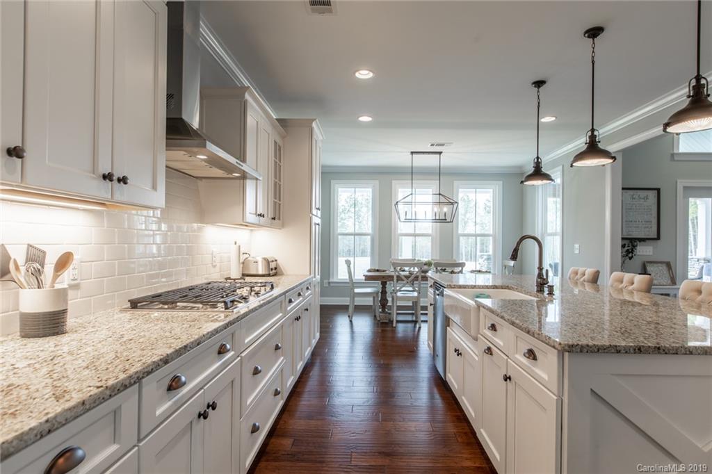 283 Currence Road Clover, SC 29710 - Photo 22 of 35 a large kitchen with stainless steel appliances granite countertop a lot of counter space and wooden floor