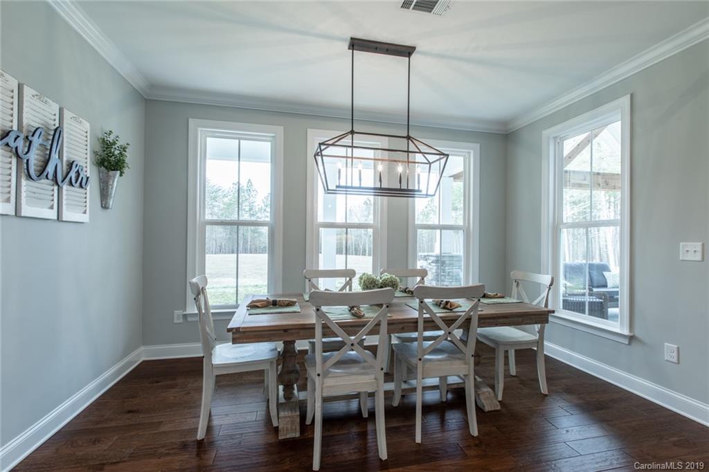 283 Currence Road Clover, SC 29710 - Photo 24 of 35 a view of a dining room with furniture window and wooden floor
