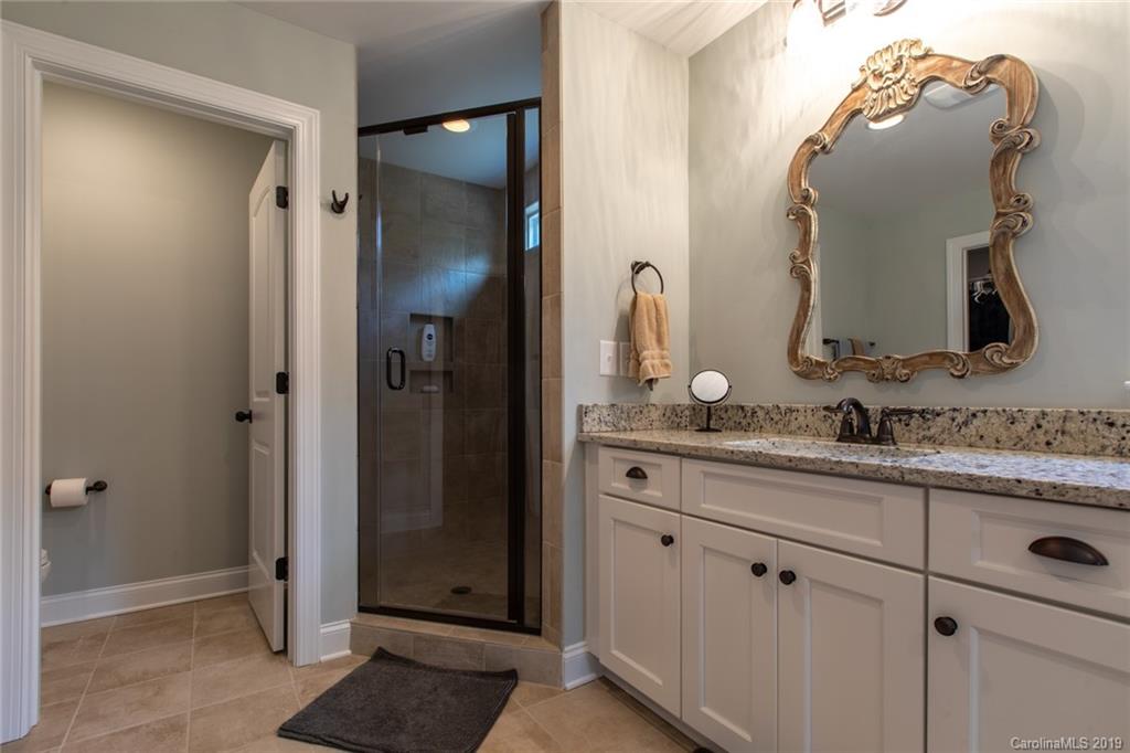 283 Currence Road Clover, SC 29710 - Photo 29 of 35 a bathroom with a granite countertop sink and a mirror