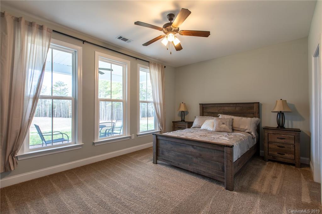 283 Currence Road Clover, SC 29710 - Photo 30 of 35 a spacious bedroom with a large bed and a large window