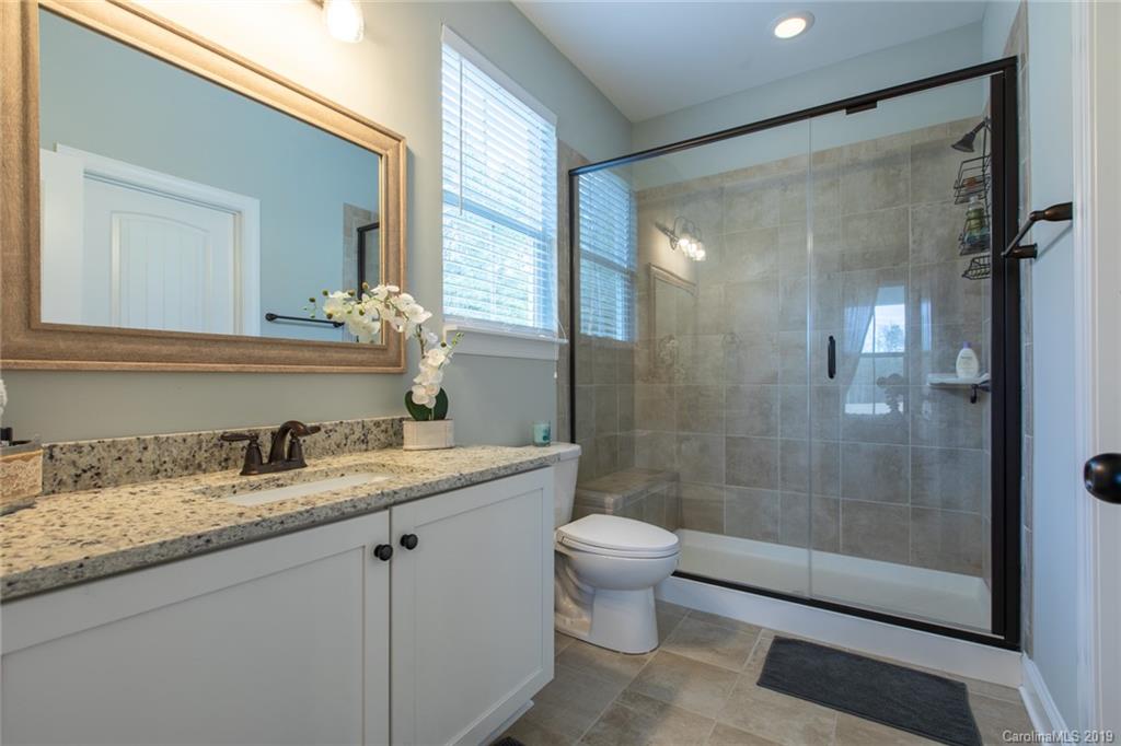 283 Currence Road Clover, SC 29710 - Photo 31 of 35 a bathroom with a granite countertop sink toilet and shower