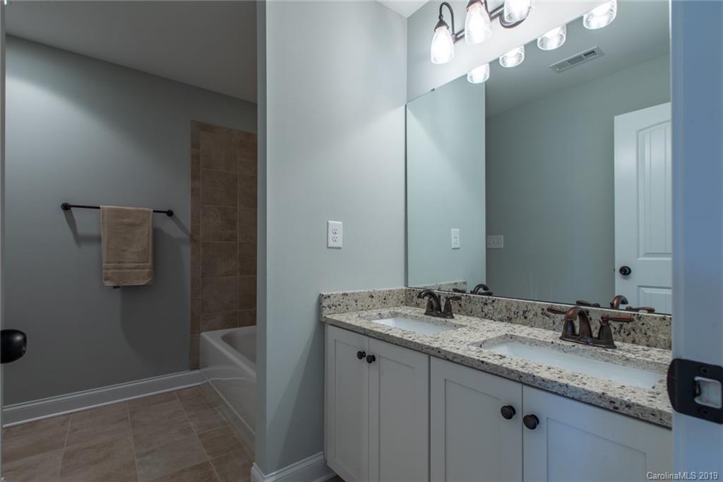 283 Currence Road Clover, SC 29710 - Photo 33 of 35 a bathroom with a granite countertop sink and a mirror