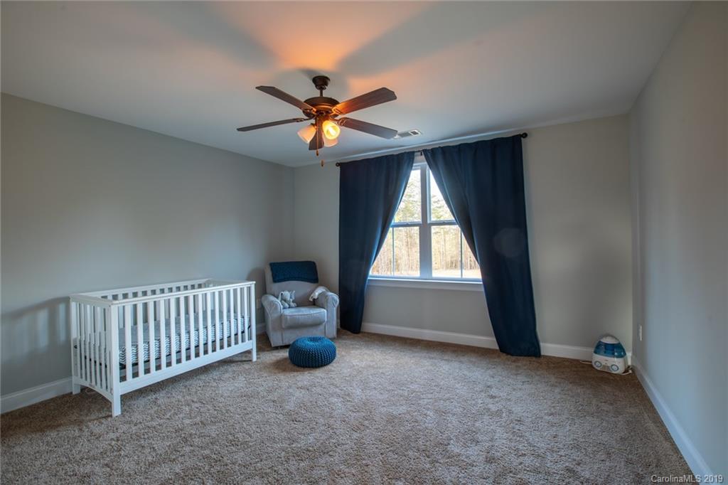 283 Currence Road Clover, SC 29710 - Photo 34 of 35 an empty room with windows and a chandelier fan