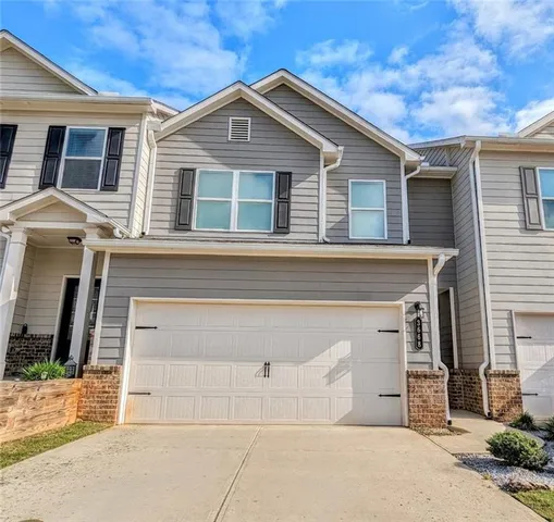 a front view of a house with a garage