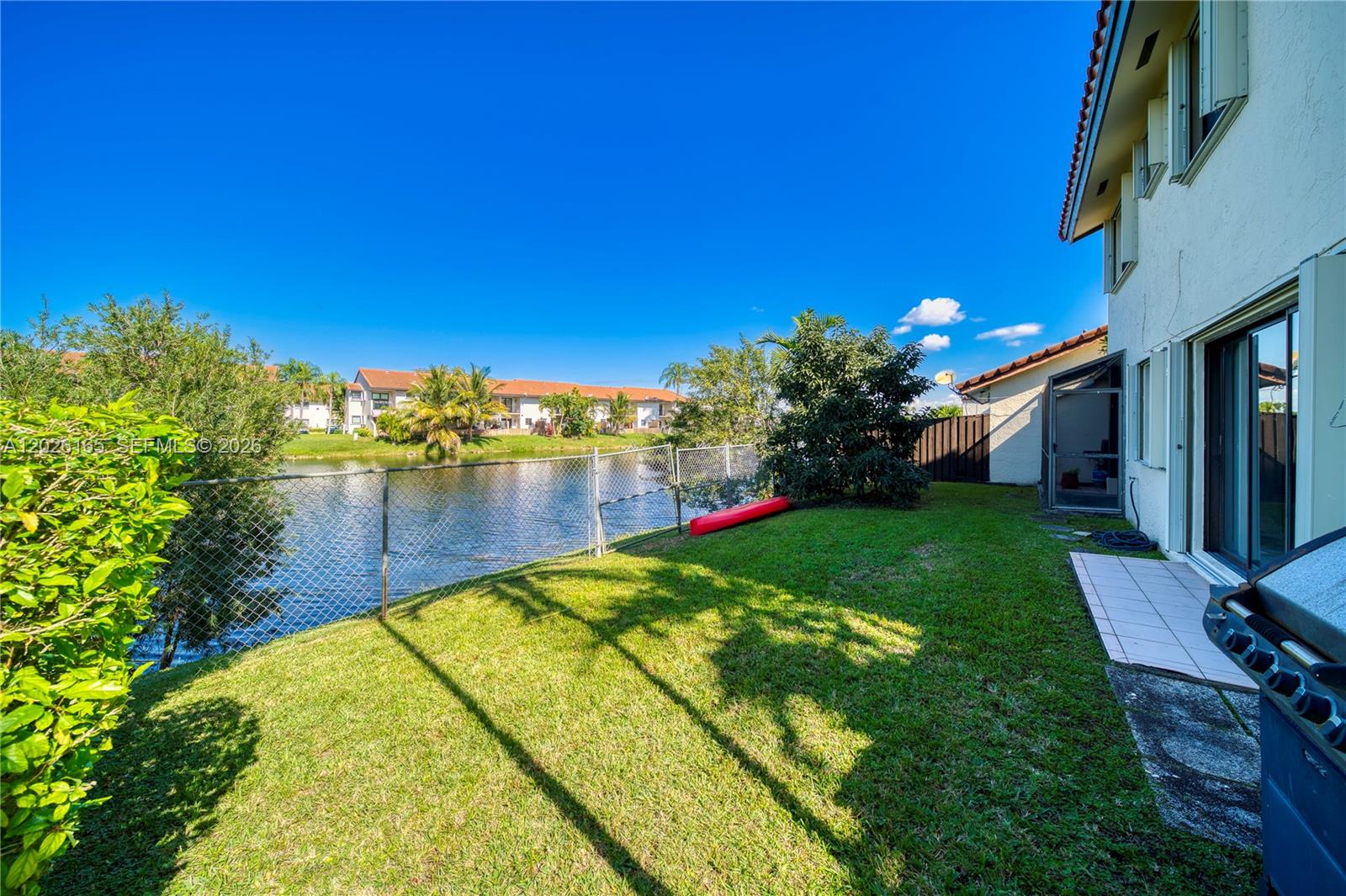 13337 Southwest 64th Lane Miami, FL 33183 - Photo 35 of 36 a view of a lake with a house in the background