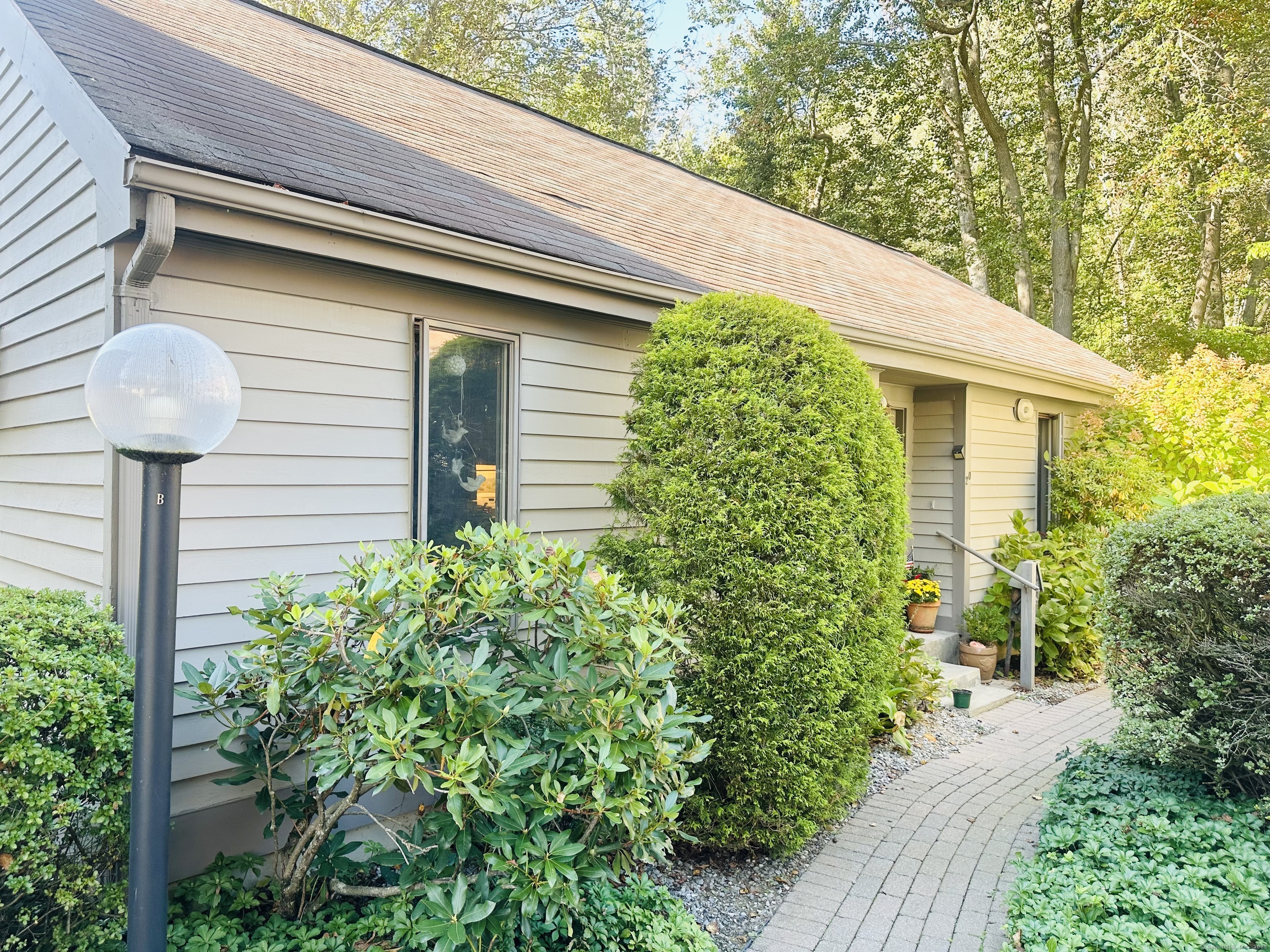 20 C Yankee Glen Road, Unit 20C Madison, CT 06443 - Photo 1 of 1 a front view of a house with garden