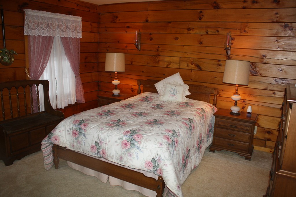 14 Brittingham Hill Road Rowe, MA 01367 - Photo 8 of 9 a bed sitting in a bedroom next to a window