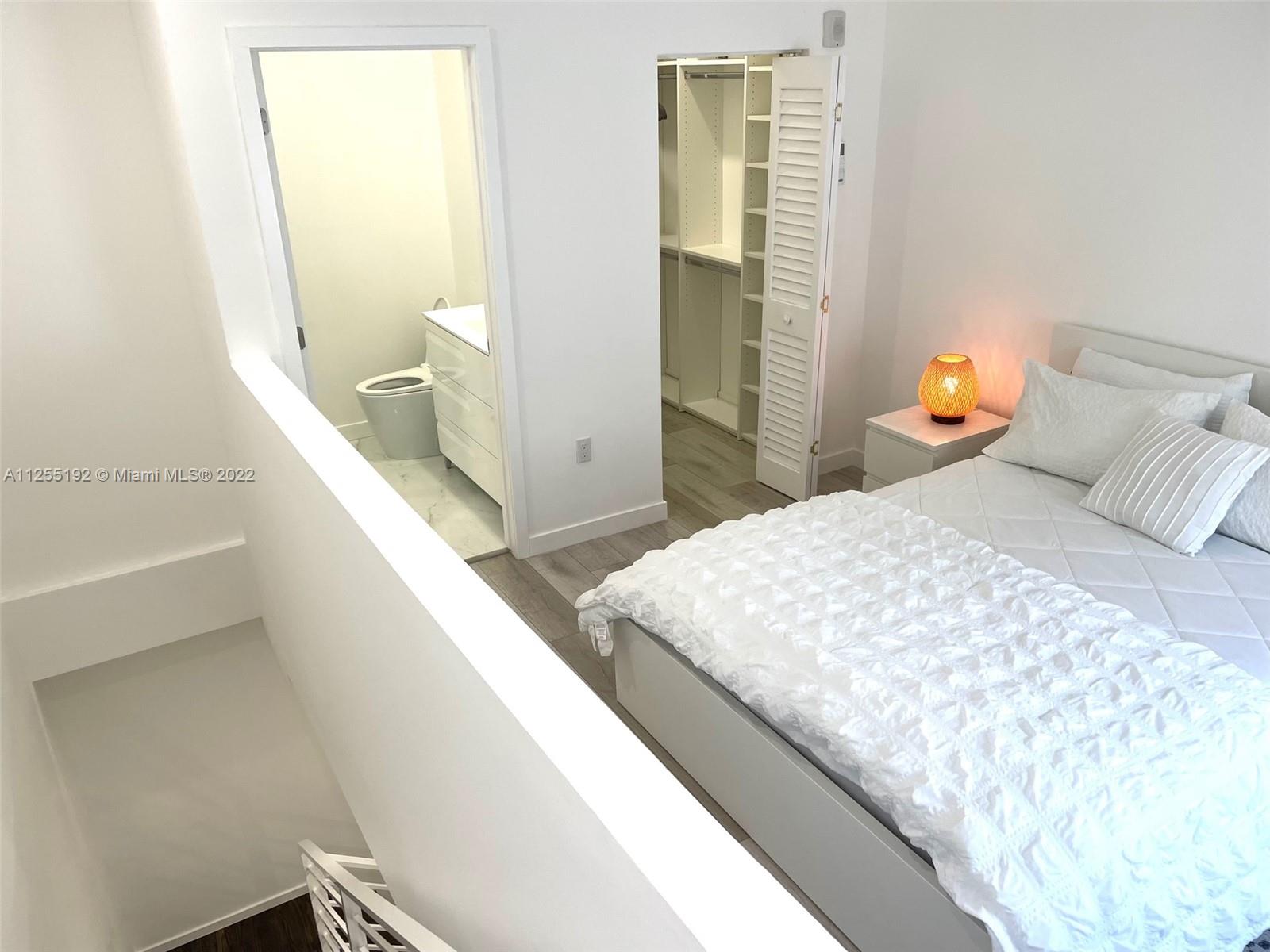 1610 Euclid Avenue, Unit A110 Miami Beach, FL 33139 - Photo 12 of 19 a bedroom with a bed and walk in closet