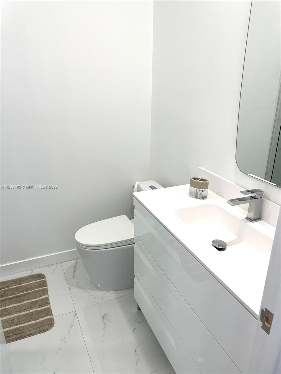 1610 Euclid Avenue, Unit A110 Miami Beach, FL 33139 - Photo 15 of 19 a bathroom with a sink a toilet and a mirror