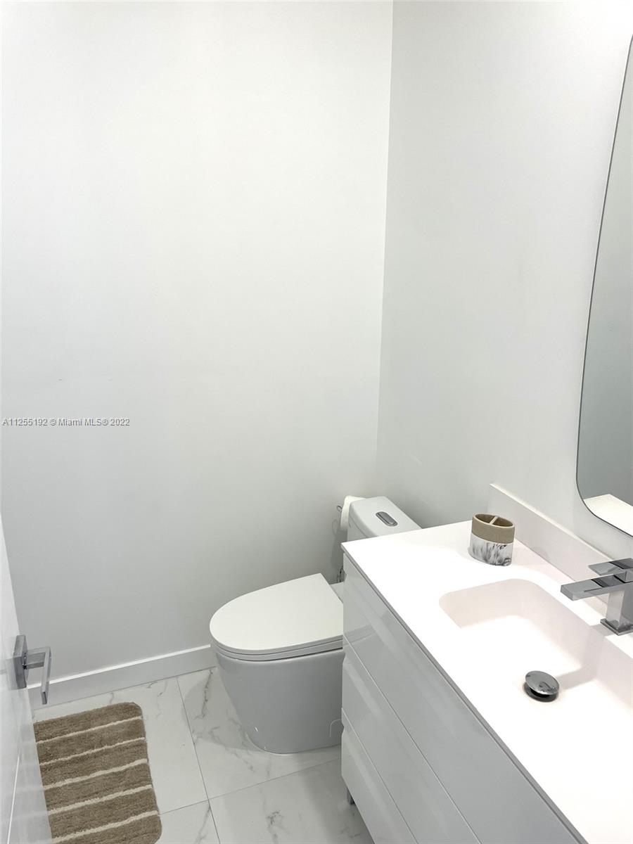 1610 Euclid Avenue, Unit A110 Miami Beach, FL 33139 - Photo 16 of 19 a bathroom with a sink a toilet and a mirror