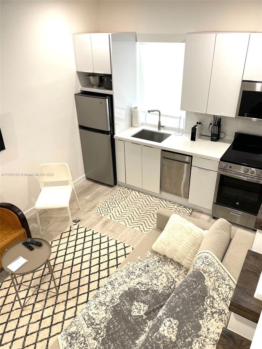 1610 Euclid Avenue, Unit A110 Miami Beach, FL 33139 - Photo 3 of 19 a kitchen with a sink cabinets and appliances