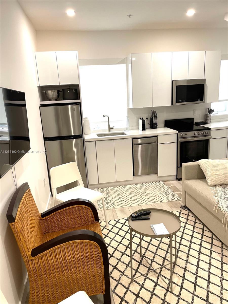 1610 Euclid Avenue, Unit A110 Miami Beach, FL 33139 - Photo 5 of 19 a kitchen with a sink cabinets and window