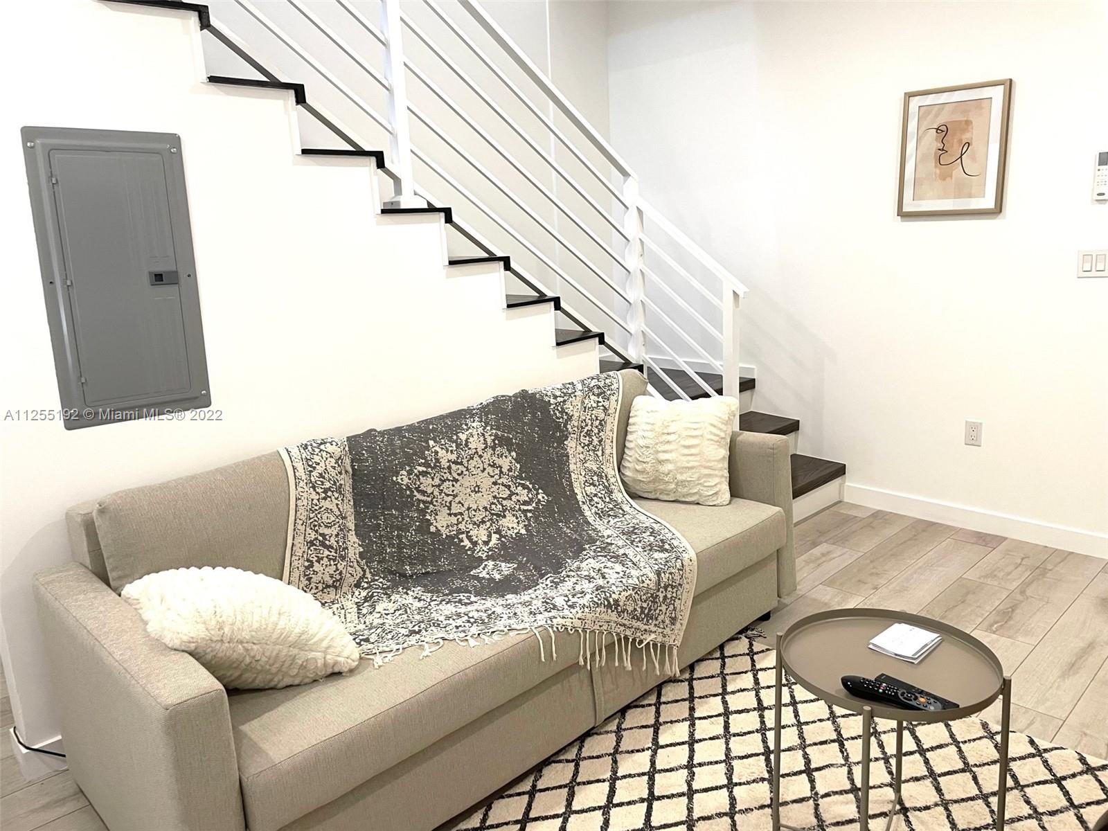 1610 Euclid Avenue, Unit A110 Miami Beach, FL 33139 - Photo 7 of 19 a living room with furniture and wooden floor