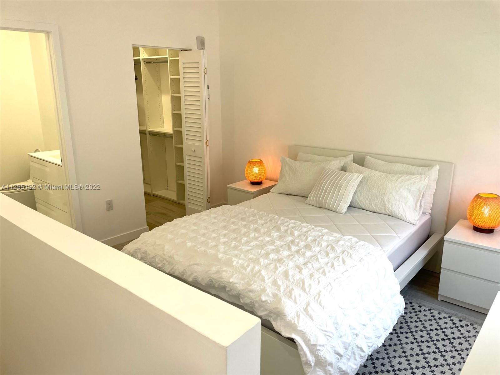 1610 Euclid Avenue, Unit A110 Miami Beach, FL 33139 - Photo 10 of 19 a bedroom with a bed and wooden floor