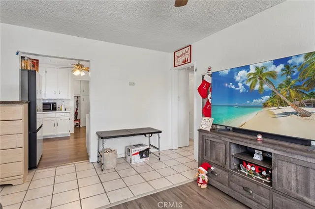 a kitchen with stainless steel appliances a white table and chairs in it