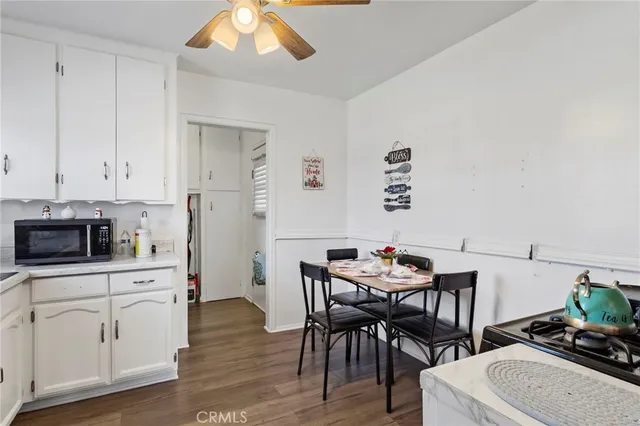 a white refrigerator freezer sitting inside of a kitchen with stainless steel appliances