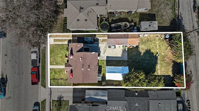 an aerial view of a house with yard