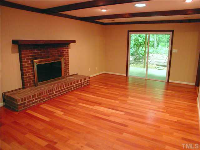 1309 Onslow Road Raleigh, NC 27606 - Photo 2 of 11 Spacious living room has pretty hardwoods, masonry fireplace