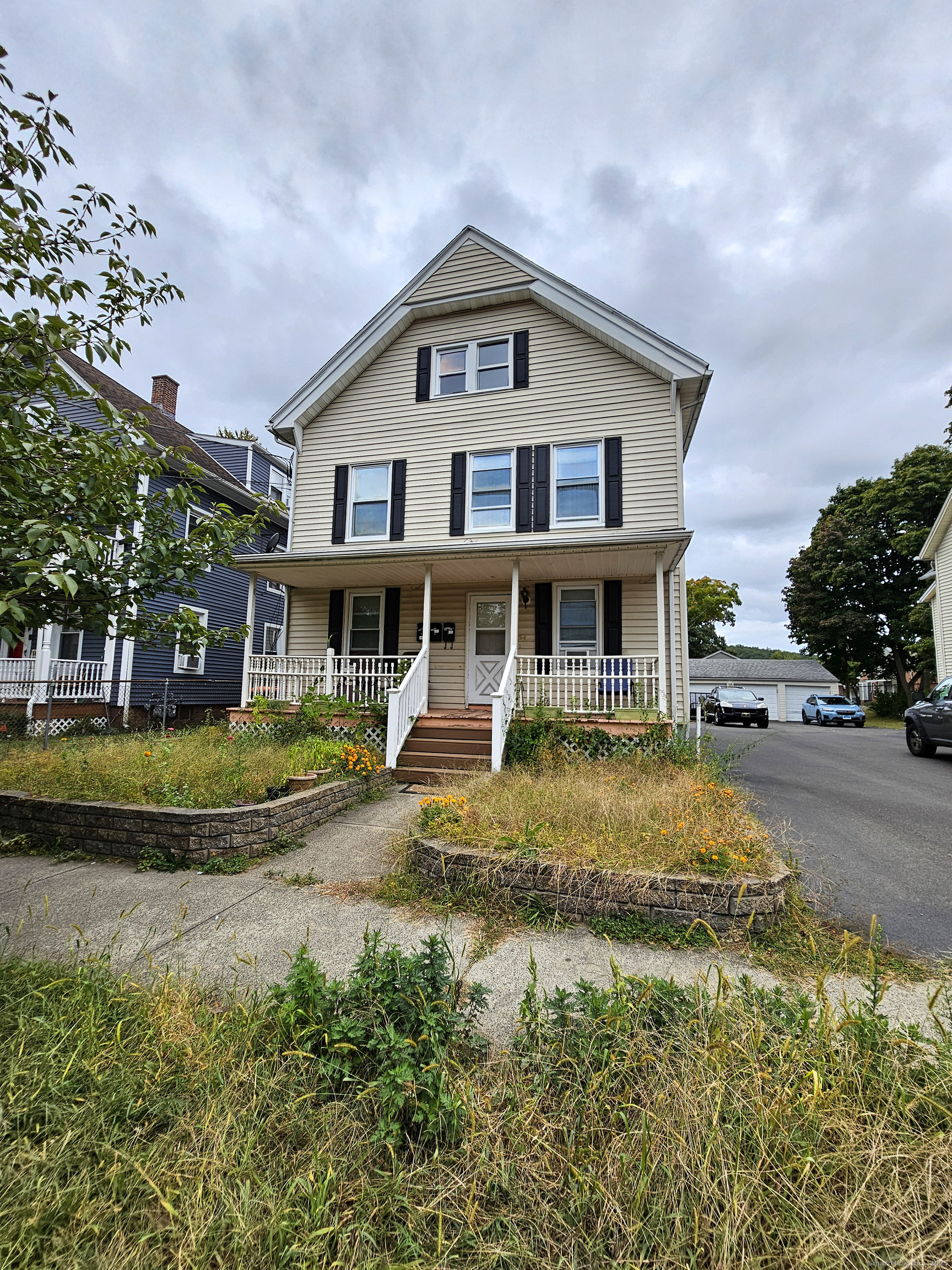 54 Washington Street, Unit 3 Wallingford, CT 06492 - Photo 1 of 9 a front view of a house with a yard table and chairs