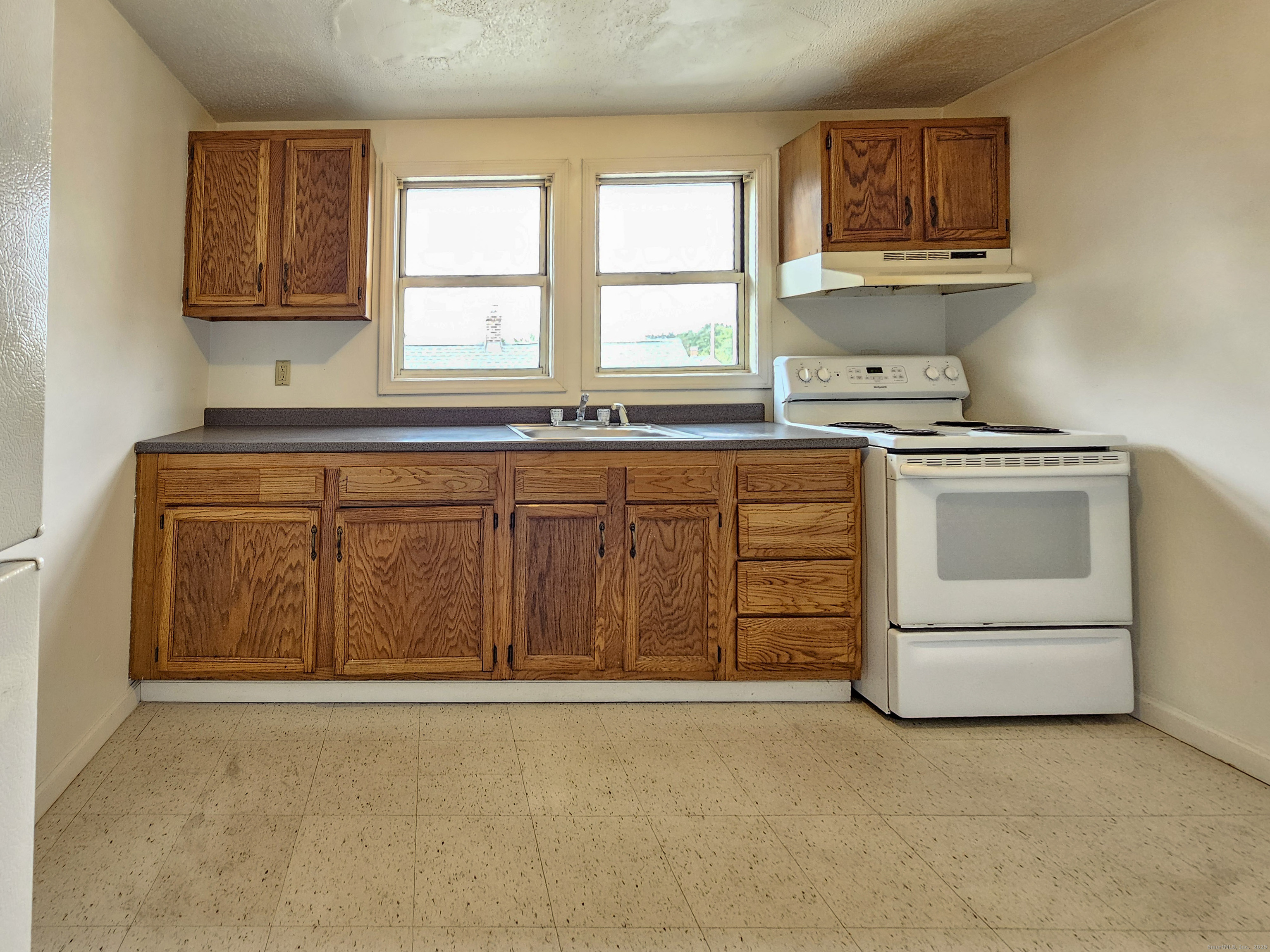 54 Washington Street, Unit 3 Wallingford, CT 06492 - Photo 3 of 9 a kitchen with stainless steel appliances granite countertop a stove a sink and a microwave
