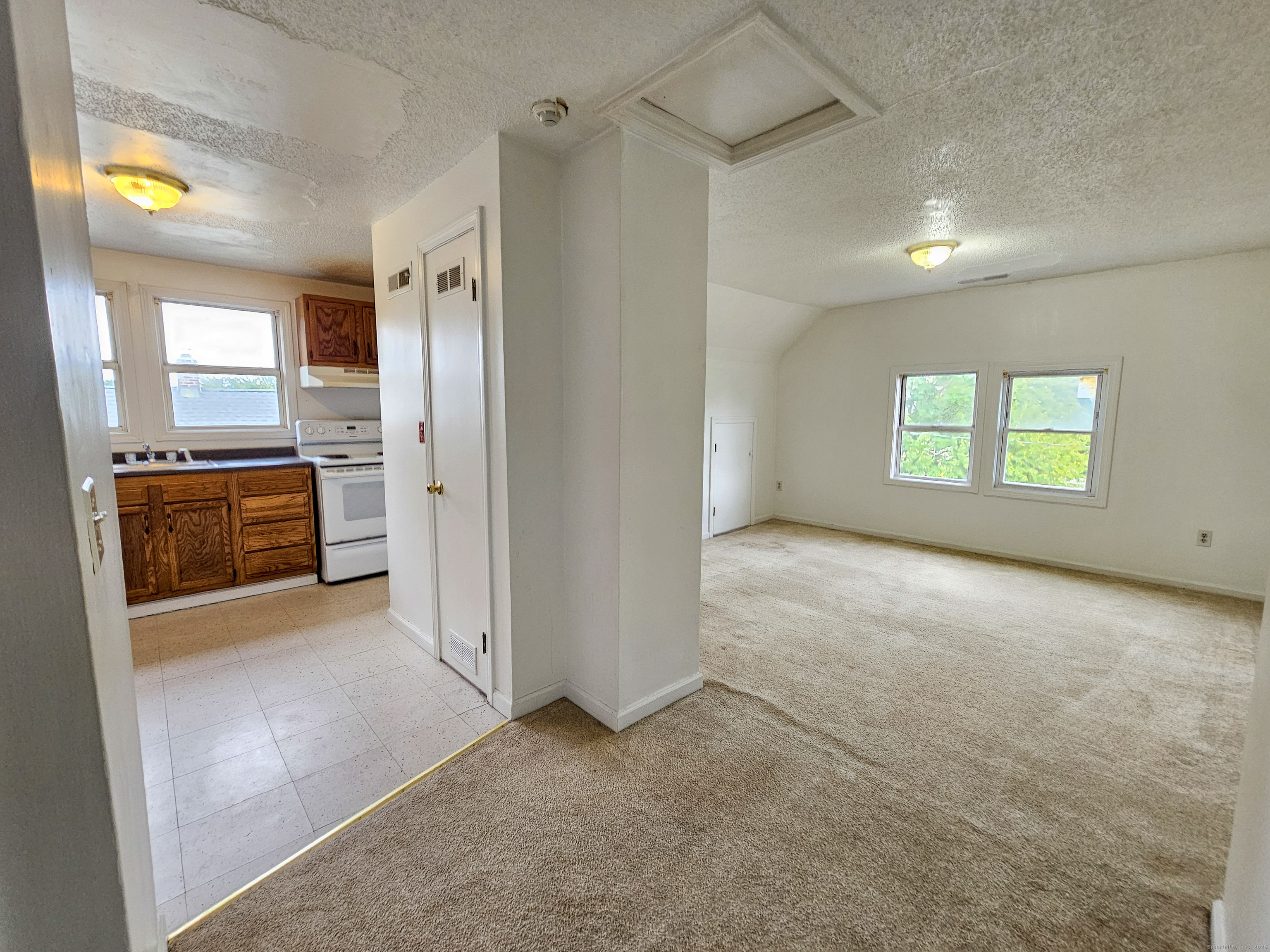 54 Washington Street, Unit 3 Wallingford, CT 06492 - Photo 4 of 9 a view of an empty room with a fireplace and a window