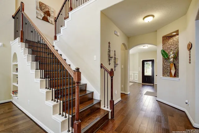 a view of entryway and hall with wooden floor