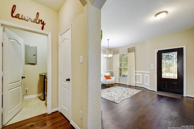 a view of a hallway view with wooden floor and living room