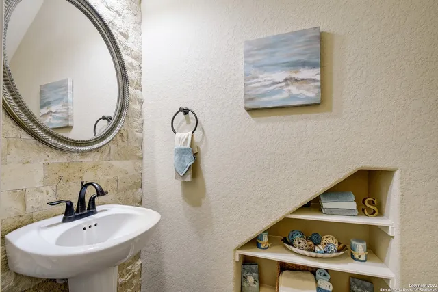 a bathroom with a sink and a mirror