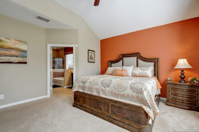 a bedroom with a bed and a lamp