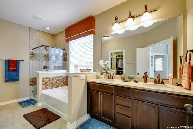 a bathroom with a tub sink and mirror