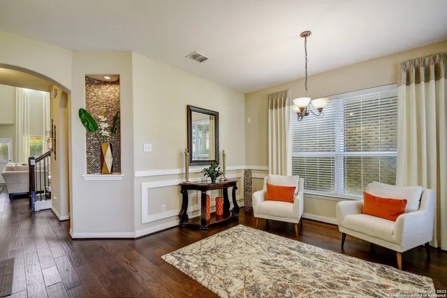a bedroom with furniture and wooden floor