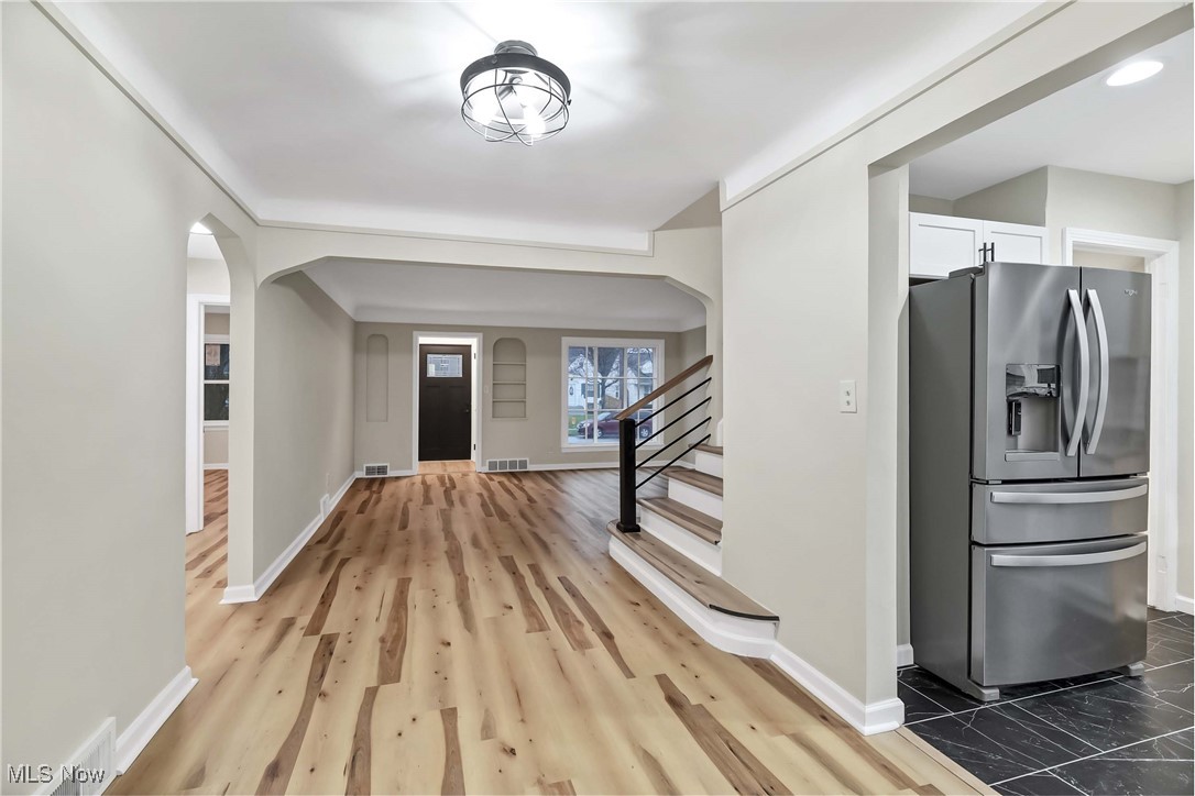 4209 Stilmore Road Cleveland, OH 44121 - Photo 11 of 36 Entryway featuring arched walkways, visible vents, baseboards, and stairway