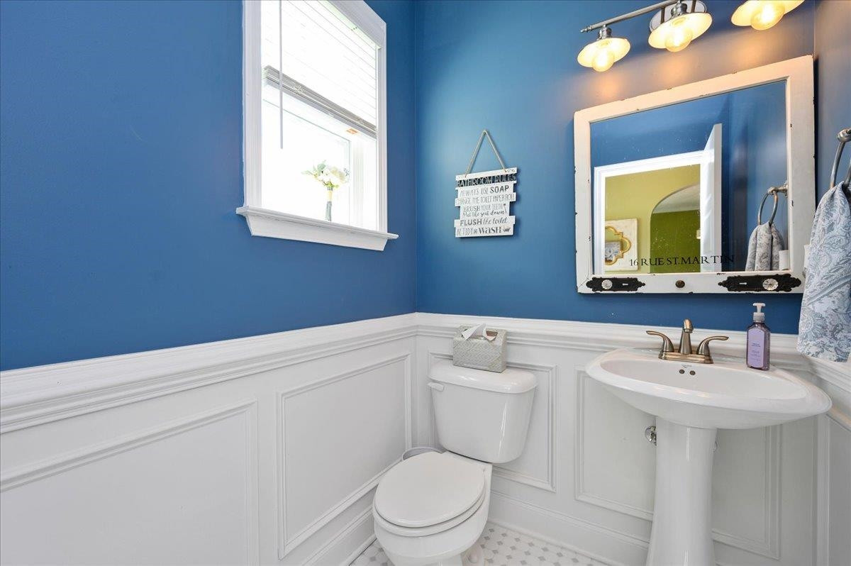 7032 Rex Road Holly Springs, NC 27540 - Photo 14 of 38 Classic floor tile and pedestal sink for a clean and soft look Powder room