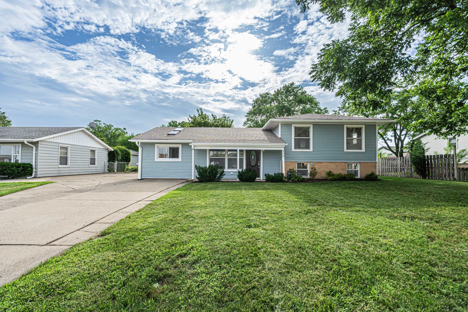 a front view of a house with a garden